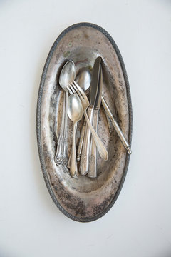 Overhead view of old silver cutlery on tray