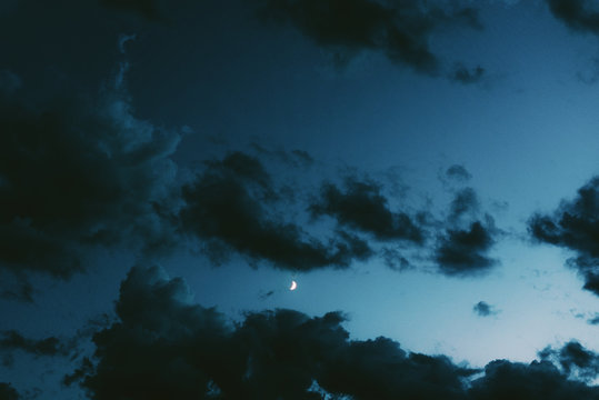 Scenic view of moon and clouds at night