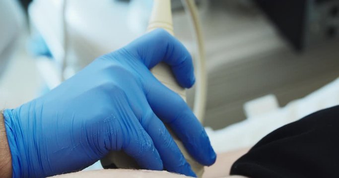 Doctor checks pregnant woman with medical 3d ultrasound.Close up
