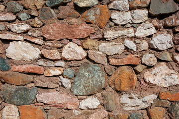 Antique gray stone wall framed by red brick. Turkish masonry.