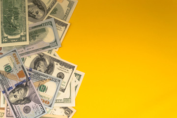 One hundred dollar banknotes on colored background top view, with empty place for your text business money concept.