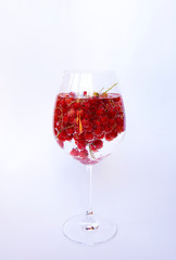 Red currant and water in a wine glass