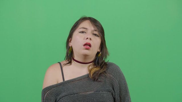 Funny Pose Tongue Farting By A Woman. Studio Isolated Shot Against Green Screen Background