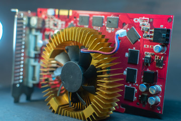 components of a personal desktop computer a disassembled board video card with a cooler lies on the case of a personal computer