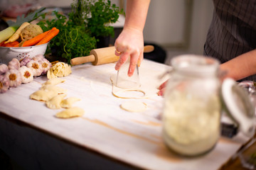 Obraz na płótnie Canvas Dumplings with meat. The housewife makes dumplings. Traditional cuisine