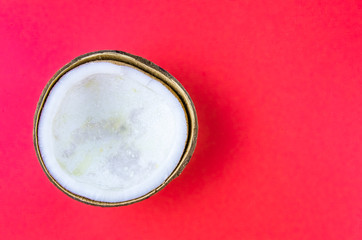 ugly food. old split coconut on a red background