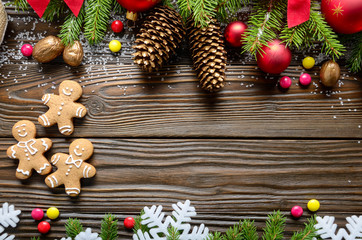 Flat lay Christmas border background of twigs, baubles, gingerbread cookies and candies with copy-space