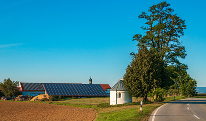 Beautiful view with a chapel and solar panels near Bamling, Bavaria, Germany