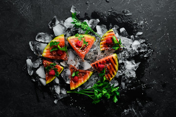 Grilled watermelon with raspberries on ice. Top view. Free copy space.