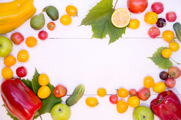 Background with vegetables. Vegetables on a white background wood texture top view. Tomatoes cucumbers peppers apples. Proper nutrition and diet. Concept of vegetarianism and detox.