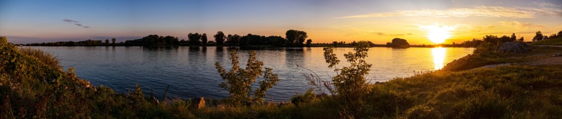 Fototapeta na wymiar Beautiful sunset with reflections in the river danube near Metten, Bavaria, Germany