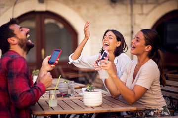 Happy friends talking and having fun at pub restaurant