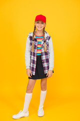 Modern outfit. Rebellious teen. Street style. Cool schoolgirl. Have fun charismatic girl on yellow background. Tomboy concept. Teen age. Girl adorable stylish outfit teenager. Comfortable outfit