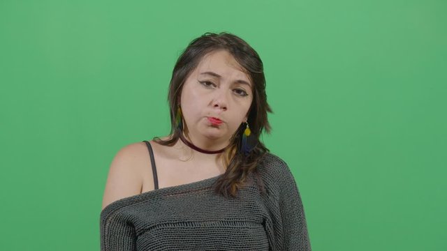 Facial Expression Of A Woman Pouting. Studio Isolated Shot Against Green Screen Background