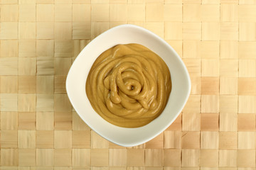 Mustard in bowl. Directly above.