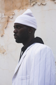 Profile of man in knit hat and striped blazer
