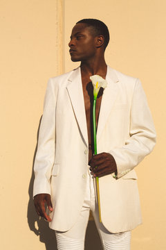 Model in white suit with calla lily