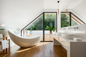 Elegant attic bathroom with bathtub - obrazy, fototapety, plakaty