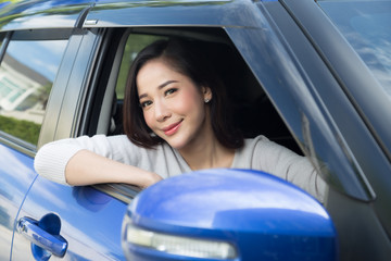 Portrait of Asian woman driving a car in a happy positive expression, Female driving with journey by car concept
