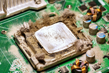 Old socket with CPU processor and dried thermal paste close-up, dust and dirt on the motherboard for restoration