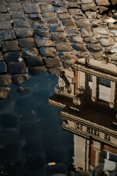 Reflection of building in pothole water