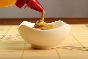 Pouring mustard into bowl