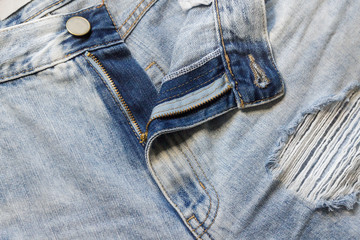 Trendy stylish jeans frayed and torn in different places.