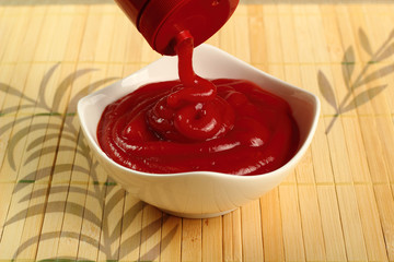 Pouring ketchup into bowl