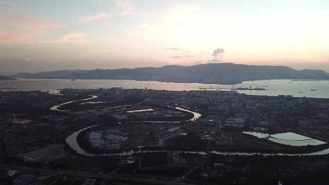 Aerial sunset over Perai area at Penang. Sungai Prai river is main river across city.