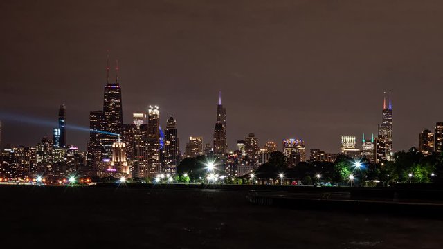 Time lapse of city skyline at night from the lakefront. Chicago is the Windy City.