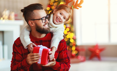happy family father and child daughter giving christmas gift