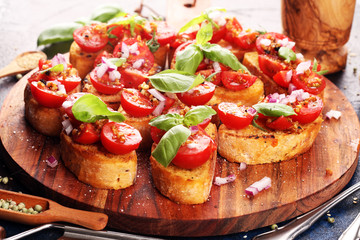 fresh tomato bruschetta. italian food appetizer with basil on table