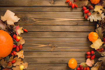 Thanksgiving background: Apples, pumpkins and fallen leaves on wooden background. Copy space for text. Halloween, Thanksgiving day or seasonal autumnal. Design mock up. Horizontal