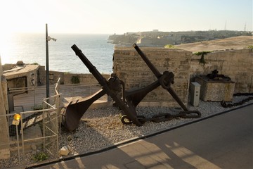 Fototapeta na wymiar Valletta, Malta, August 2019. Anchors in a military museum on the background of the bay. 