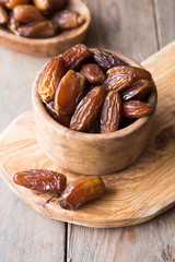 Dates palm fruit in wooden bowl is snack healthy..