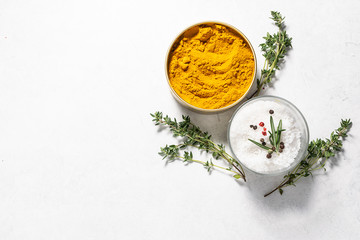 Natural organic turmeric, sea salt and thyme on white background with copy space for your text....