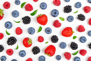 Strawberry, blueberry, blackberry, raspberry on white background, top view. Berries pattern, flat lay. Texture of fresh summer berries on white background. Creative food concept