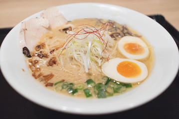 Chciken soup ramen served with eggs, bean sprouts, green onion, etc. Shallow depth of field.