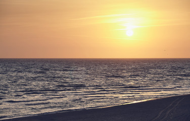 Scenic sunrise over the sea, color toned picture.