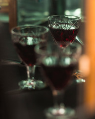 glass of wine in the reflection of the mirror