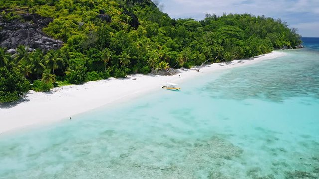 Aerial 4k footage of tropical exotic beach with lonely tourists, perfect white sand and turquoise lagoon water
