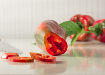 Red pepper cut with a knife. Healthy eating concept.