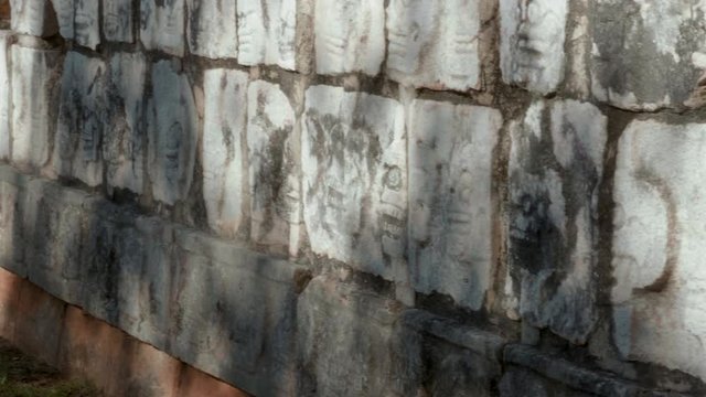 Aztec rock brick wall with beautiful ancient carvings, Side dolly shot