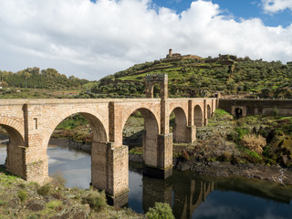The Puente de Alcantara, a Roman arch bridge in Toledo, Catile-La Mancha, Spain, spanning the Tagus River. The word comes from Arabic bridge