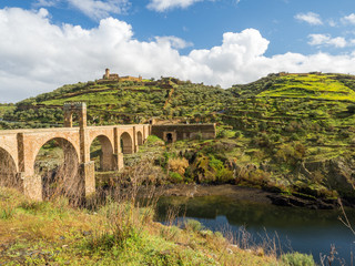 Fototapeta premium The Puente de Alcantara, a Roman arch bridge in Toledo, Catile-La Mancha, Spain, spanning the Tagus River. The word comes from Arabic bridge