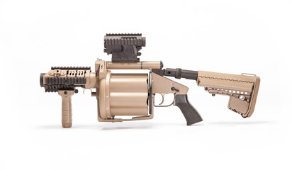 Tan grenade launcher facing right in studio on white background.