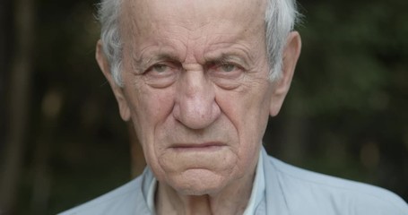 Old man face holding his wife, close up, slow motion