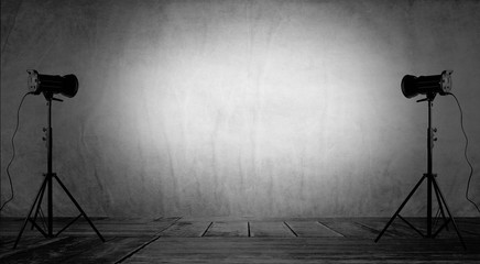 Empty photo studio with lighting equipment.