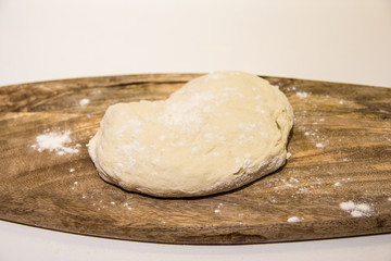 dough with flour on a wooden background