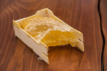 honey in honeycomb on wooden background